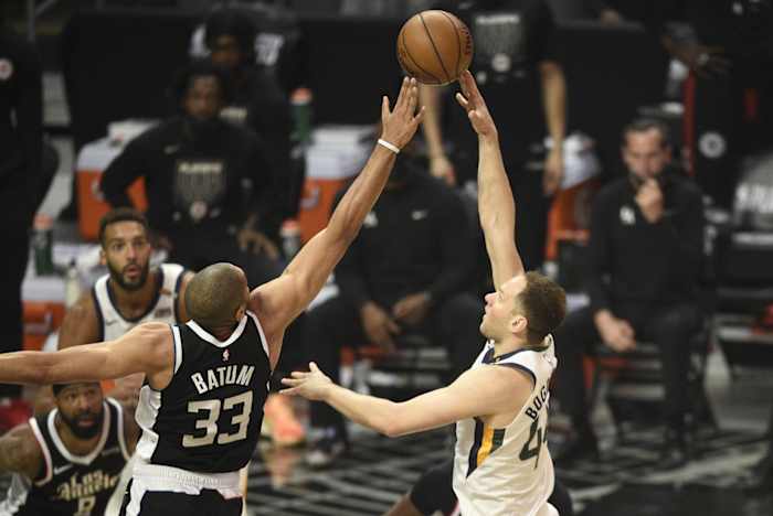 Bojan Bogdanovic (44) scores over Nicolas Batum (33)
